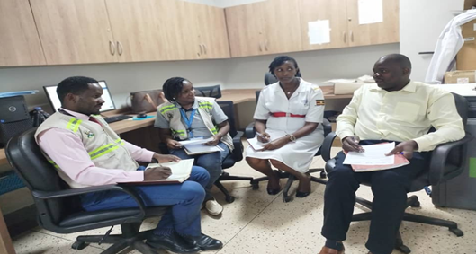 AEC Field inspectors interact with representatives of a medical facility